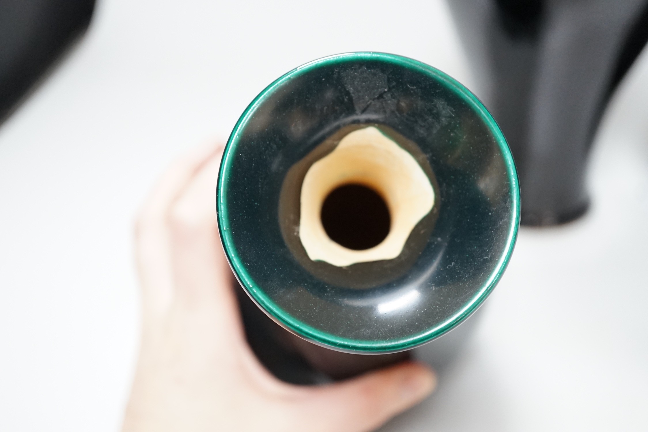 A Chinese black ground plum vase, together with a near pair of Chinese vases, tallest 24cm